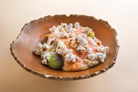 Corn cream with popcorn and roasted kiwi