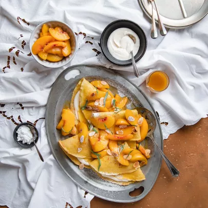 Crêpes with Lemon Crème Fraîche and Maple Syrup Peaches 