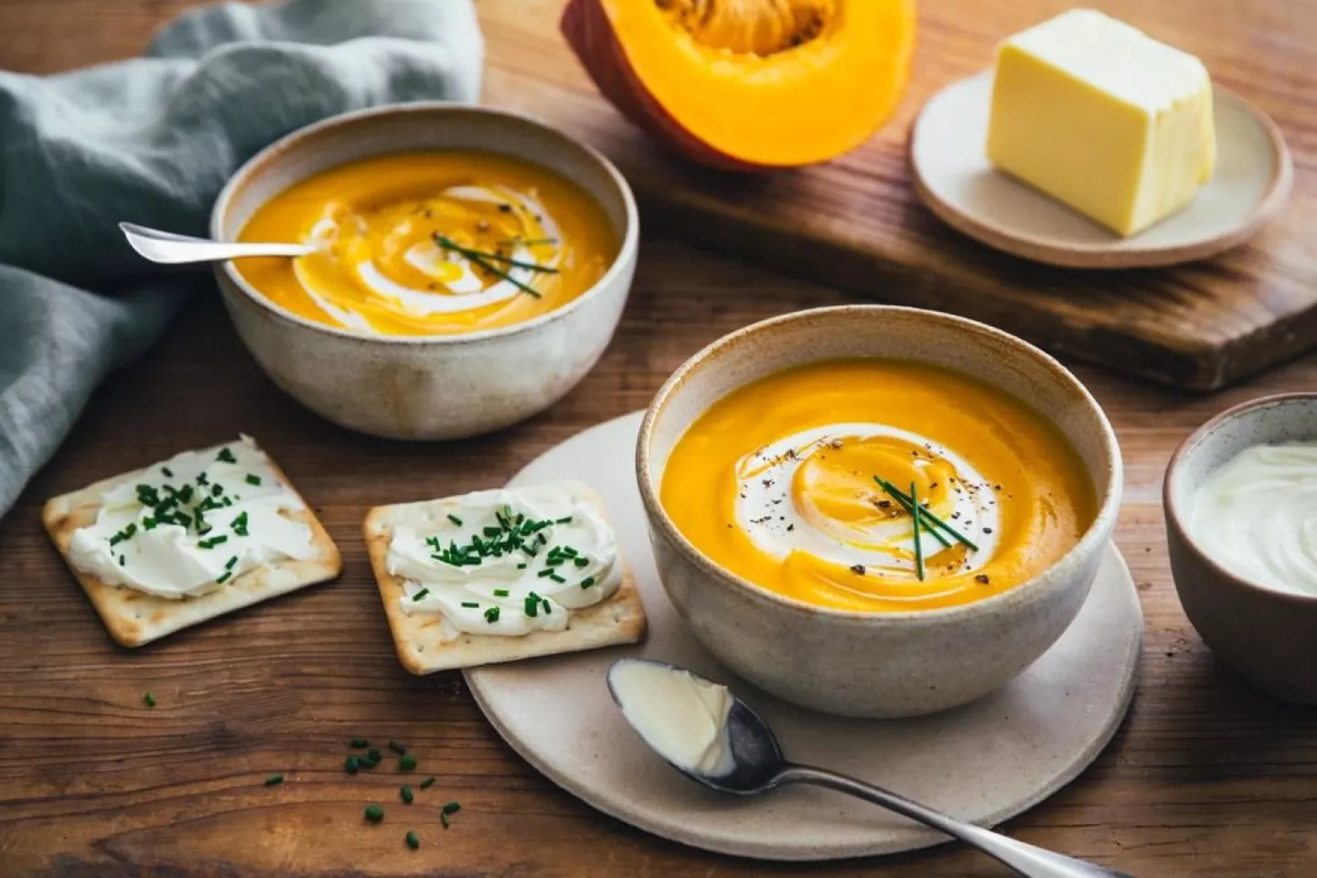 Pumpkin velouté, cream cheese crackers and chives  photo